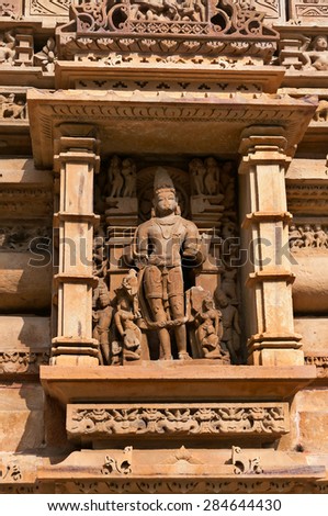 Stone carved sculpture of god Male Deity on Lakshmana temple. Western temples of Khajuraho. Madhya Pradesh. India. Built around 999