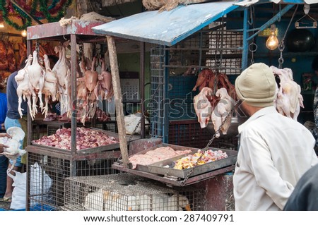 BANGALORE, INDIA - DEC 25, 2014: Indian men sell chicken on Russell Market. Russell Market is a shopping market in Bangalore, built in 1927 by the British.