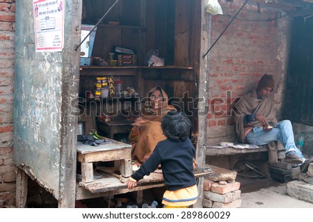 VARANASI, INDIA - DEC 24, 2014: Indian small tea shop on the ghat at cold foggy winter morning. Varanasi. Uttar Pradesh