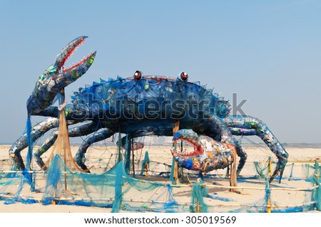 Fort Kochi, India -Jan 7,2015: Mad Crab on beach installation art with Waste Plastics. Plastics and similar non-biodegradable wastes form the most important threat to marine ecosystems in 21st century