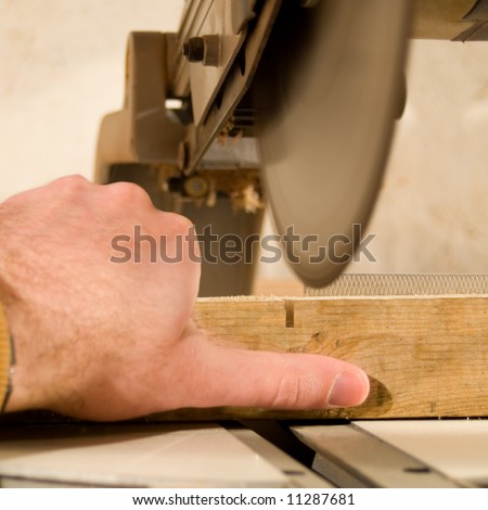 A sharp saw blade is going to cut of a workers thumb