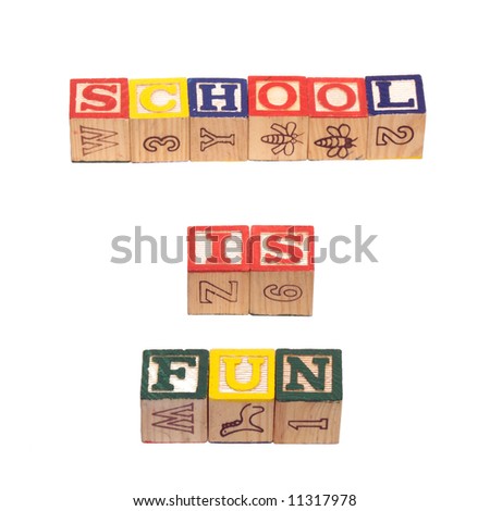 baby letter blocks. The words school is fun, spelled out using wooden aby letter blocks