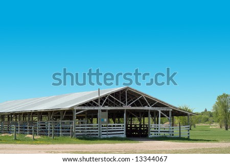 A hollowed out cattle barn, shot on a clear sunny day