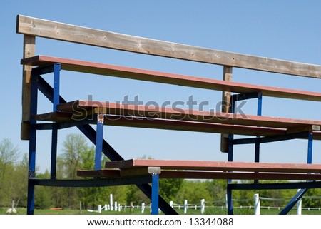 Low angle view of a set of school bleachers, shot against a blue sky