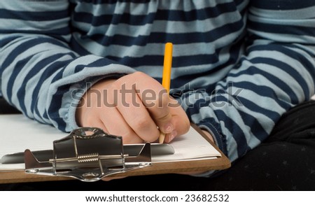 Closeup view of someone writing some notes on a clipboard