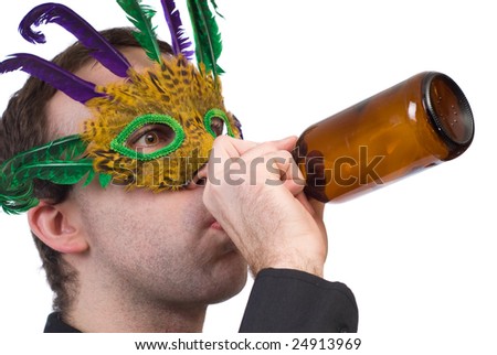 Closeup view of a man wearing a feather mask drinking from a beer bottle, isolated against a white background