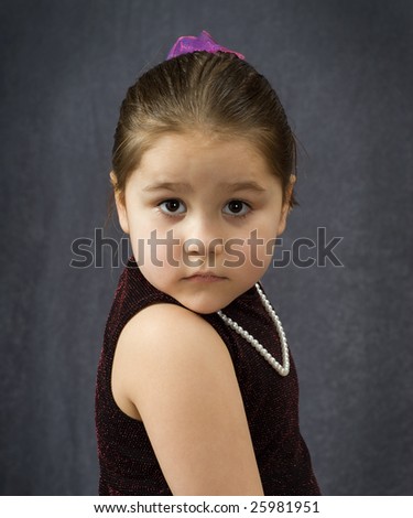 A formal portrait of a female toddler with a serious expression on her face
