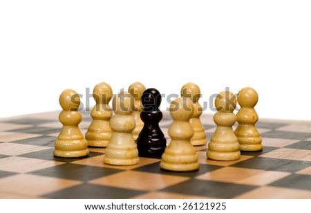 Concept image of racism with some white chess pawns surrounding a black one