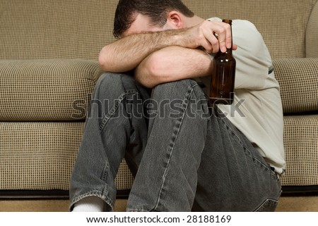 A depressed man coping with his depression by drinking alcohol