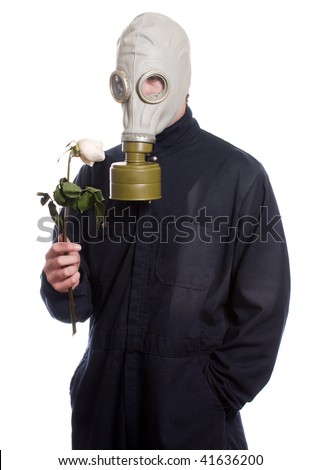 A guy wearing a gas mask is holding a wilting rose, isolated against a white background