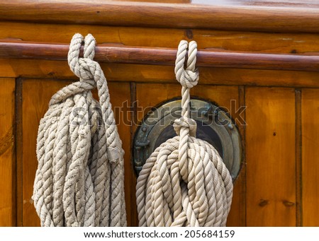 Ropes tied on the deck of an old wooden boat