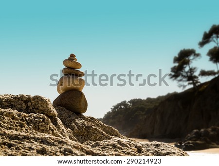 Stacking stones on the rocks of a cove. Zen garden. Zen stones. Meditation.