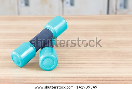 Fitness dumbbells  on the desk wooden
