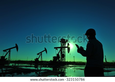 Oil field oil workers at work