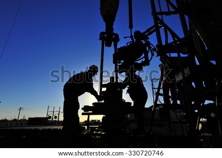 Oil field oil workers at work