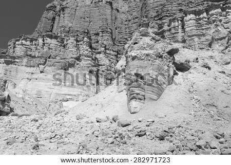 Black and white huge rock stones shapes cliffs face gestalt.
