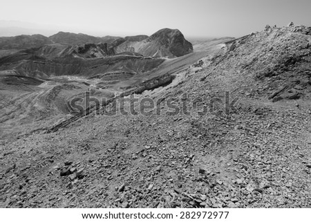 Desert trail footpath black and white mountains trees, Eilat mountains, Negev, Israel.
