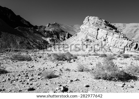 Infrared black and white, B&W, stone desert mountain cliff crag, Negev desert, Israel.