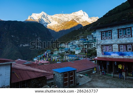 Kongde Ri mountain snow peaks  view above Namche Bazaar village hotels houses, Everest Base Camp trail traveling route, Nepal.