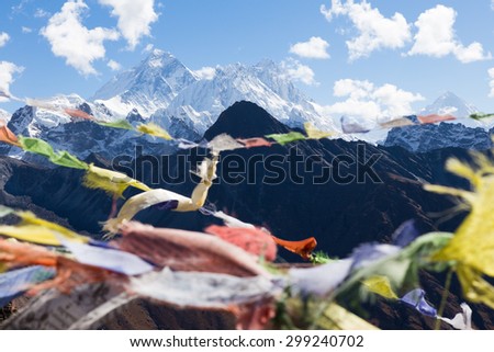 Buddhist prayer flags, Gokyo Ri mountain summit peak, snow mountains peaks. Everest Base Camp trail route, trekking Nepal culture, Himalaya ridge traveling.