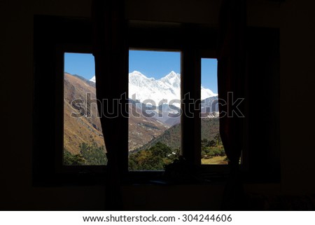 Everest Lhotse Nuptse snow peaks ridge and river canyon valley view through hotel resort room window. Everest Base Camp trekking route trail, Nepal tourism.