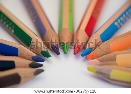 Set of crayons pointing to the center on white background