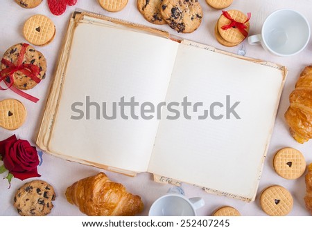 Valentines day background. Valentines day breakfast. Blank book with cookies and roses on white wooden table