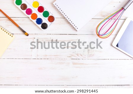 Sketch pad with paints, brush, whisk and tablet. Concept of creativity. Desktop workplace designer, artist, painter. Modern trend template for advertising, mockup, layout, template, banner.