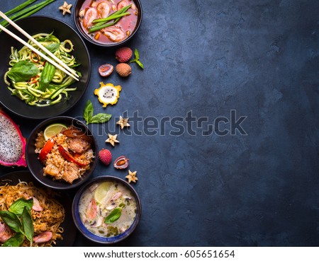Thai food background. Dishes of thai cuisine. Tom yum, tom kha gai, pad thai noodles, fried rice with pork and vegetables khao phat mu, green papaya salad som tam, thai fruits. Space for text