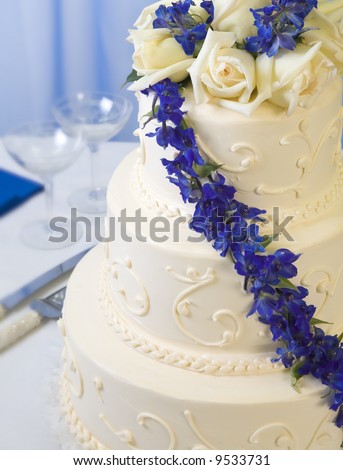 stock photo traditional decorated wedding cake with blue delphiniums and 