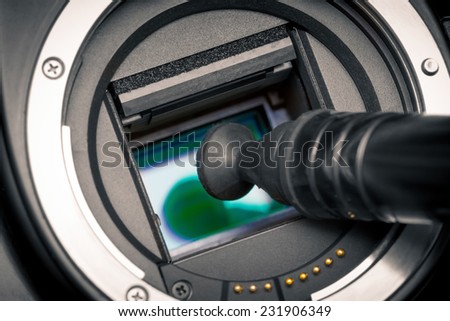 Image photo sensor being cleaned with a lens pen. DSLR APS-C.