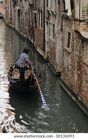 Venice gondolier in the canals of Venice.