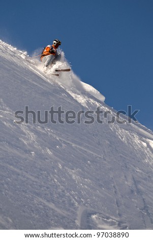 Freeride Skier moving down  in powder snow.