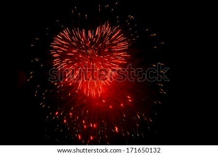 Red fireworks in the night sky in the form of heart