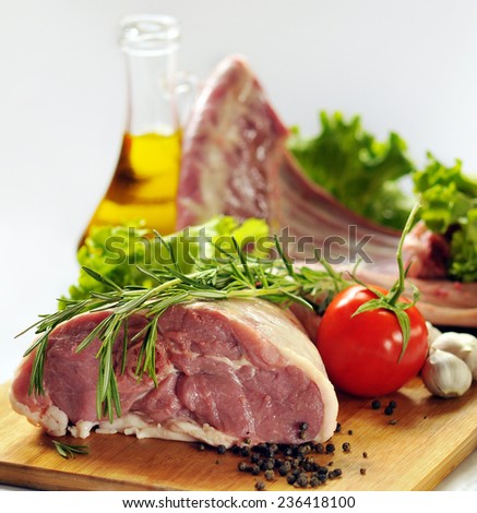 Raw lamb  meat with vegetables  on white background.