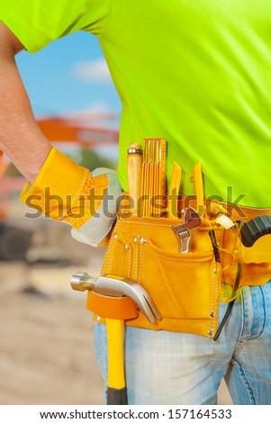 worker with tools in belt
