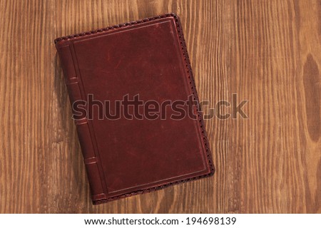 leather book on wooden board