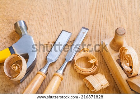 set of woodworking tools chisel hammer plane on wooden board