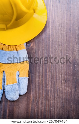 glove and helmet on vintage wooden board with copyspace construction concept