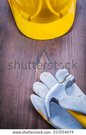 claw hammer glove helmet on vintage wooden board
