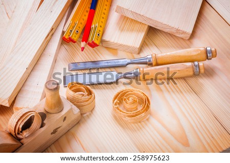 woodworkers plane chisels wooden meter pencil shavings on wooden boards