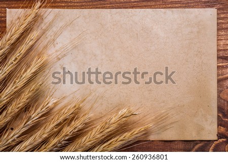 organized copyspace old blank paper and ears of wheat on vintage wooden board food and drink concept