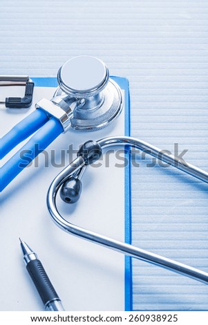 clipboard with white blank paper and stethoscope on blue background medical concept