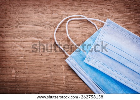 two blue surgical mask on wooden board medical concept
