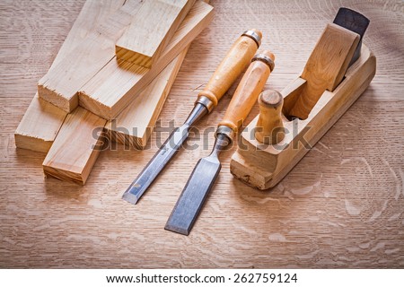composition chisels woodworkers plane and wooden planks on board construction concept
