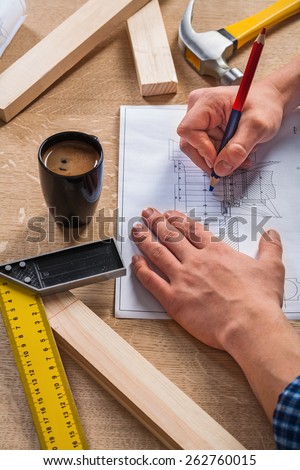 worker hands on table with square ruler hammer coffee in cup construction concept