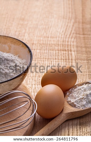 organized copyspace flour in bowl and spoon eggs on vintage wooden board food and drink concept