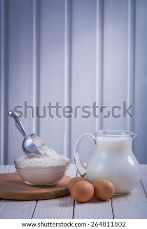 pitcher with milk bowl flour eggon white painted wooden board food and drink still life