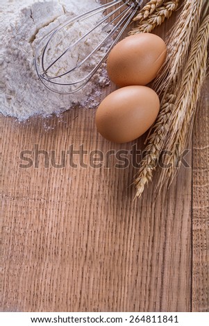 organized copyspace heaf of four eggs corolla wheat ears on wooden board food and drink concept
