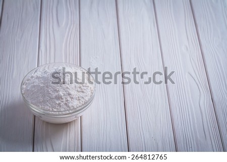 bowl with white natural flour on white painted old wooden board food and drink concept